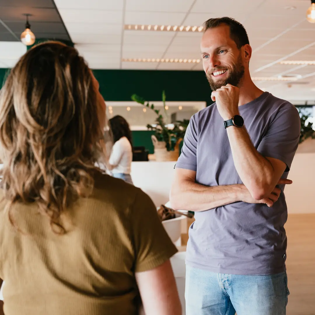 Collega's lachen en praten met elkaar op werk op kantoor