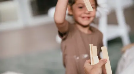 Werken bij CompaNanny meisje speelt met houten blokjes
